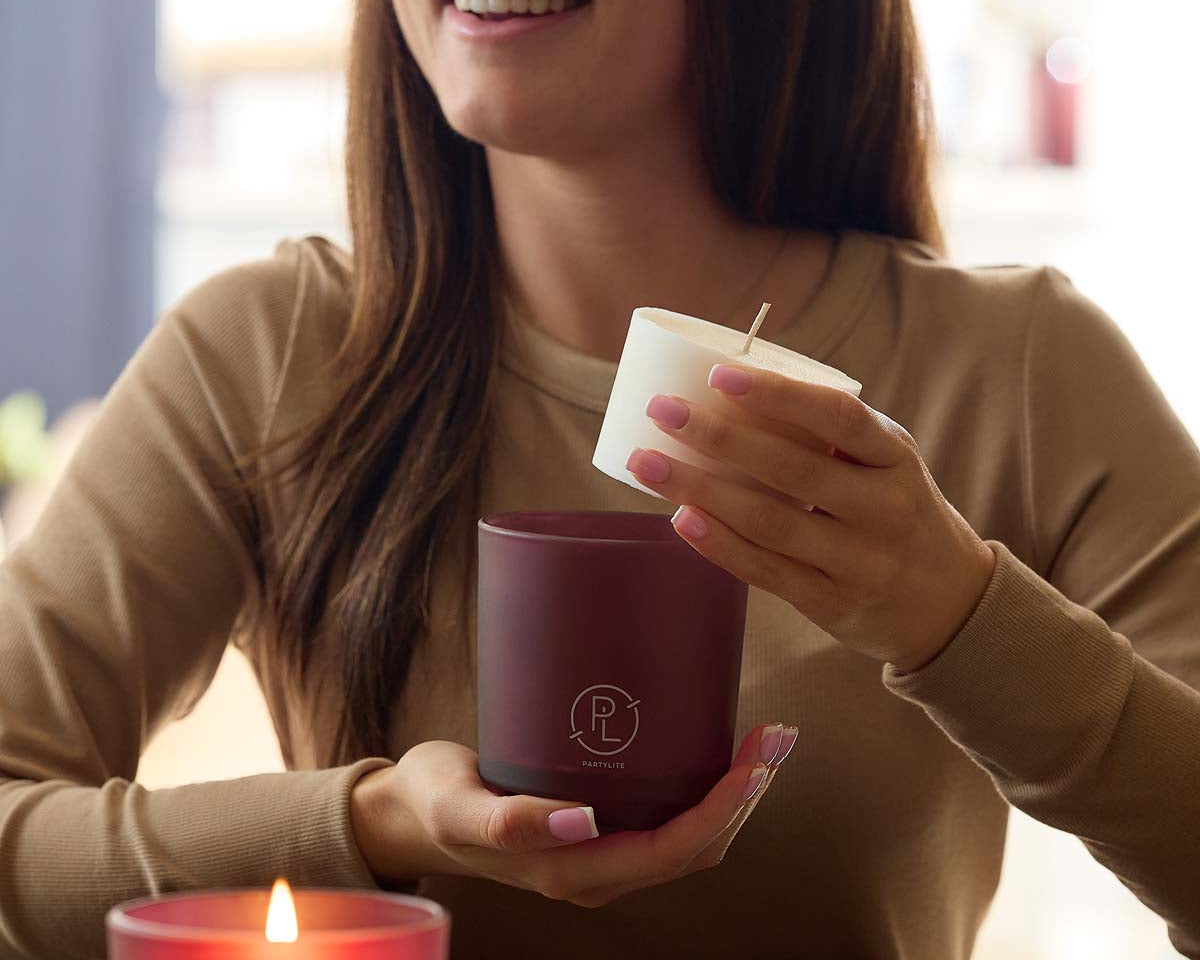 Mulberry Refillable Jar candle being demonstrated in the hands of a lady.
