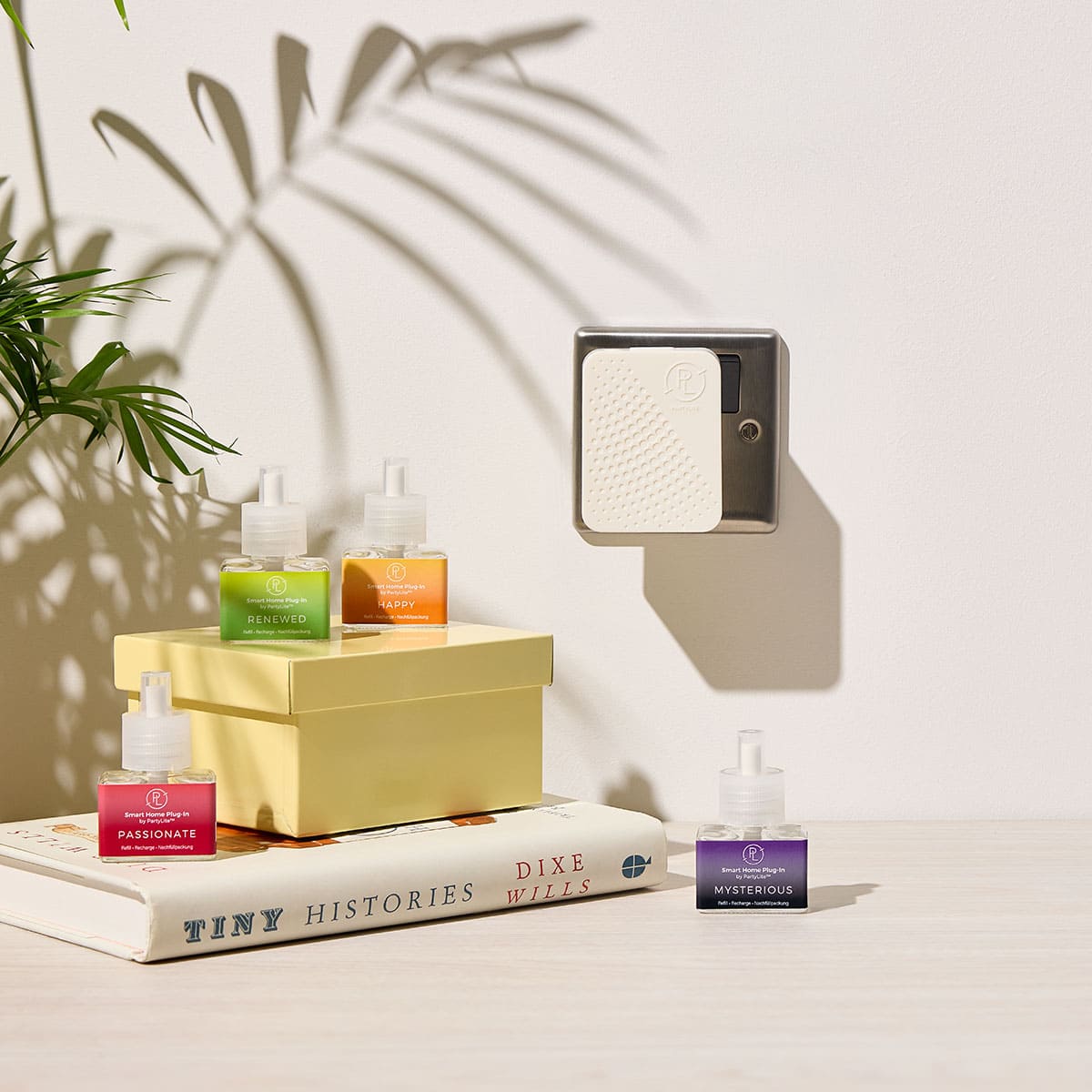 Smart Home Plug In, shown plugged into a wall socket with Mood Refills shown on a book with a white background